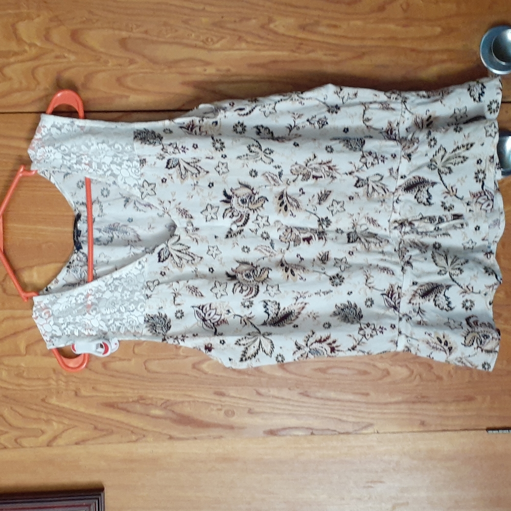 Cream colored tank top with a brown paisley and floral design